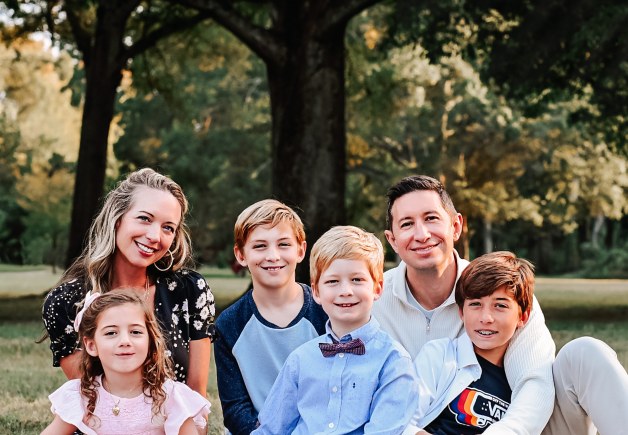 Drew Fisher with his wife and four children, outdoors